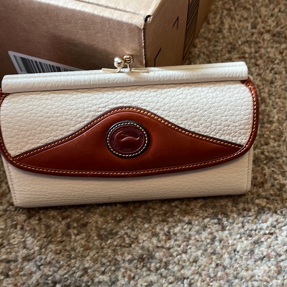 Like new Dooney and Bourke cream wallet.